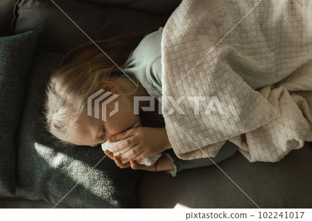 Sick little girl lying in a bed. 102241017