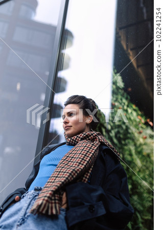 Young woman walking outdoor, in autumn city. Young woman walking outdoor, in autumn city. 102241254