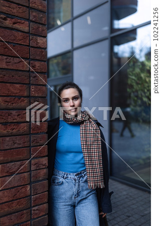 Young woman walking outdoor, in autumn city. Young woman walking outdoor, in autumn city. 102241256