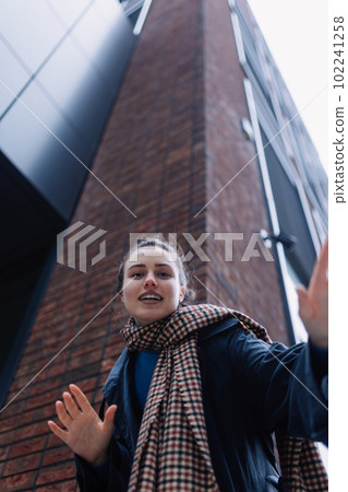 Young woman walking outdoor, in autumn city. Young woman walking outdoor, in autumn city. 102241258