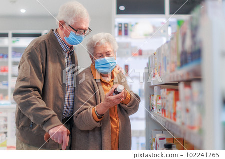 Senior couple looking for medicine in pharmacy store. 102241265