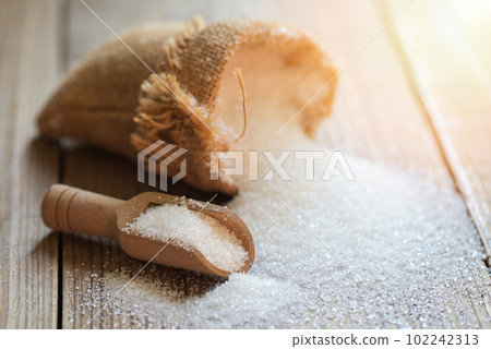 white sugar for food and sweets dessert candy heap of sweet sugar crystalline granulated, Sugar on sack and wooden background 102242313