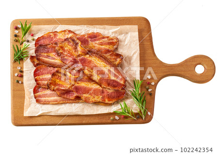 board with fried bacon strips and rosemary isolated on white background, top view. 102242354