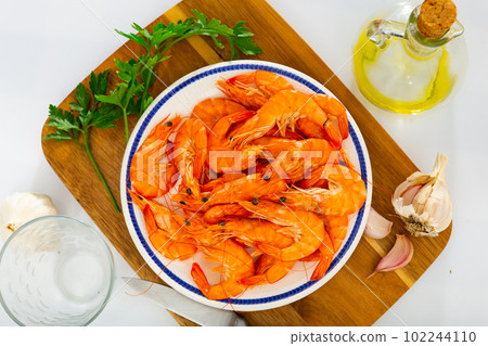 Dish of Spanish cuisine - baked in oven langoustine served with lemon Dish of Spanish cuisine - baked in oven langoustine served with lemon 102244110