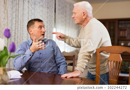 Man quarreling with elderly father 102244272