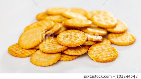 Crispy salted round crackers on white table Crispy salted round crackers on white table 102244548