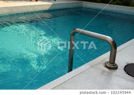 Swimming pool with stainless handrails at resor 102245944