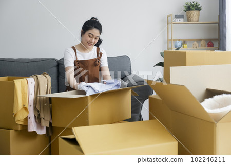 Modern female people in moving home apartment leisure indoor activity alone. Modern female people in moving home apartment leisure indoor activity alone. 102246211
