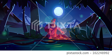 Man near campfire, forest with mountain landscape 102248992
