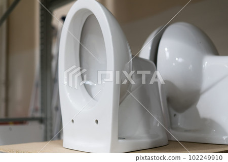 Lot of white toilets in hardware store, plumbing department Lot of white toilets in hardware store, plumbing department 102249910