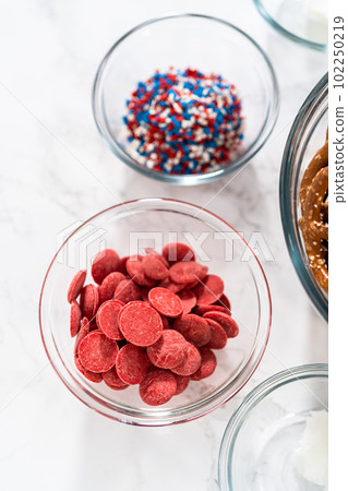 Measured ingredients in glass mixing bowls to prepare red, white, and blue chocolate-covered pretzel twists. Measured ingredients in glass mixing bowls to prepare red, white, and blue chocolate-covered pretzel twists. 102250219