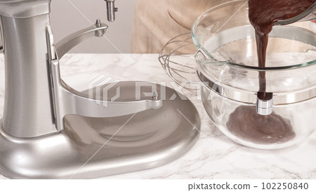 Step by step. Whipping chocolate ganache with an electric kitchen mixer. 102250840