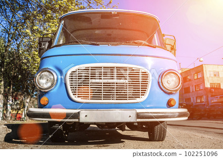 Vintage blue bus. Retro van hippie camper car on sunny street of the city.  102251096