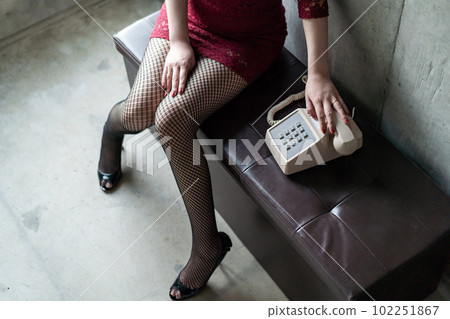 A woman putting a hand on the receiver 102251867