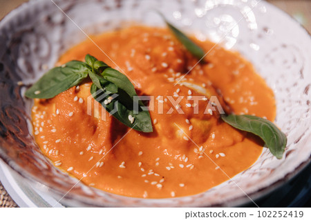 Delicious vegan food on plate. Orange sauce with soy patties Delicious vegan food on plate. Orange sauce with soy patties 102252419