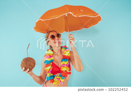 Woman cover herself from the sun radiation with an umbrella 102252452