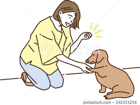 Smiling young woman training her dog Smiling young woman training her dog 102253258