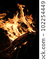 a campfire burns in the night, lights on a black background 102254449