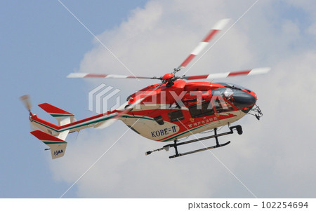 A BK-117 rescue helicopter of the Kobe City Fire Department demonstrating a maneuver flight during a disaster drill 102254694