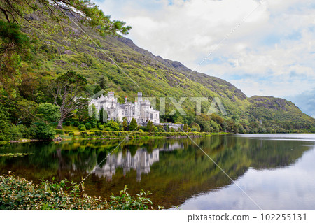 Kylemore Abbey with water reflections in Connemara, County Galway, Ireland, Europe. Benedictine monastery founded 1920 on the grounds of Kylemore Castle. Mainistir na Coille Moire 102255131