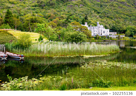 Kylemore Abbey with water reflections in Connemara, County Galway, Ireland, Europe. Benedictine monastery founded 1920 on the grounds of Kylemore Castle. Mainistir na Coille Moire 102255136