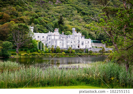 Kylemore Abbey with water reflections in Connemara, County Galway, Ireland, Europe. Benedictine monastery founded 1920 on the grounds of Kylemore Castle. Mainistir na Coille Moire 102255151