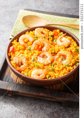 Arroz Con Camarones Yellow Rice with Shrimp closeup on the plate. Vertical 102255211