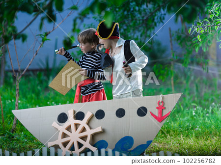 children play pirates at backyard children play pirates at backyard 102256782