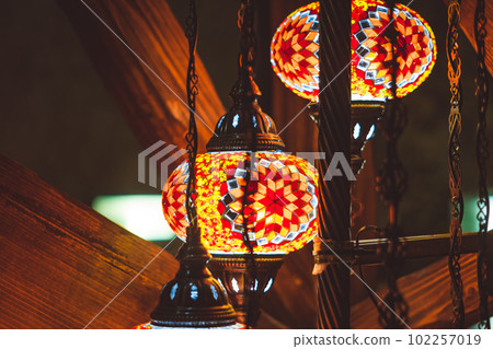 patterned lamp hanging from glass 102257019