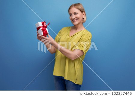 joyful blond middle-aged woman received her birthday present 102257446