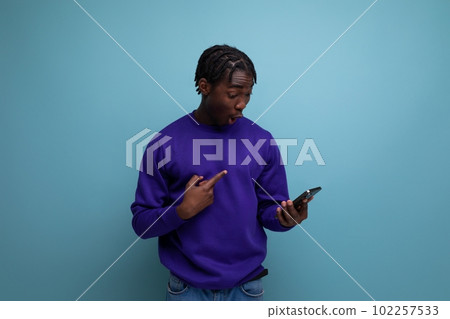 handsome dark-skinned european young man with smartphone for electronic payment handsome dark-skinned european young man with smartphone for electronic payment 102257533