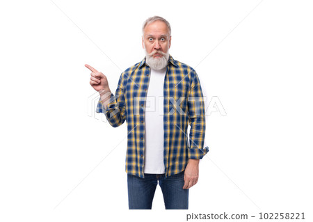 handsome elderly gray-haired retired man with mustache and beard points his finger 102258221