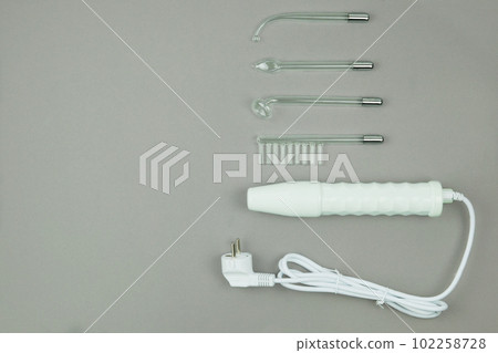 Darsonval for body and hair care on a grey background. Therapy for skin. Top view. Copy space. 102258728