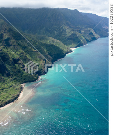 Aerial Na Pali Coast State Park on Kauai, Hawaii. High quality photo. Beautiful mountain backdrop of Hawaii's Na Pali Coastline with steep cliffs. Shot on Sony A7iv from a helicopter. Aerial Na Pali Coast State Park on Kauai, Hawaii. High quality photo. Beautiful mountain backdrop of Hawaii's Na Pali Coastline with steep cliffs. Shot on Sony A7iv from a helicopter. 102259558