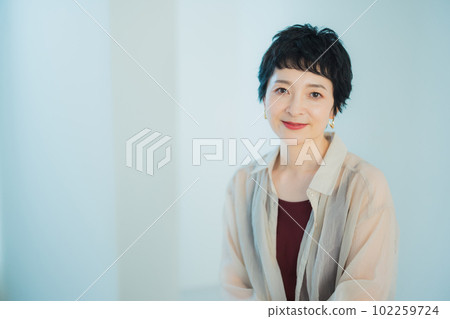 Middle-aged woman with very short hair Middle-aged woman with very short hair 102259724