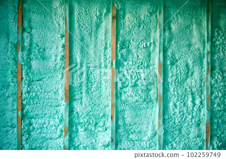 Cropped view of wall in wooden frame house thermal insulated by polyurethane foam. Construction and insulation concept. Cropped view of wall in wooden frame house thermal insulated by polyurethane foam. Construction and insulation concept. 102259749