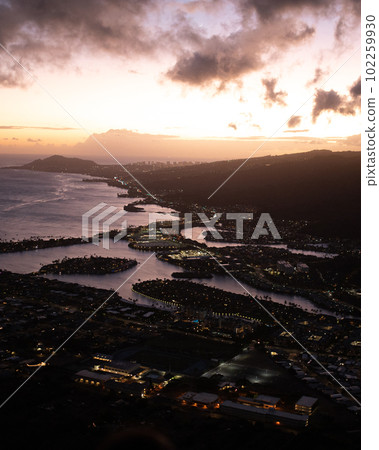 Sunset from top of Koko Head Crater. High quality photo. A railroad track hike up a mountain on Oahu, Hawaii.	 102259930