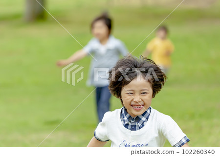 Children playing in fresh green park 102260340