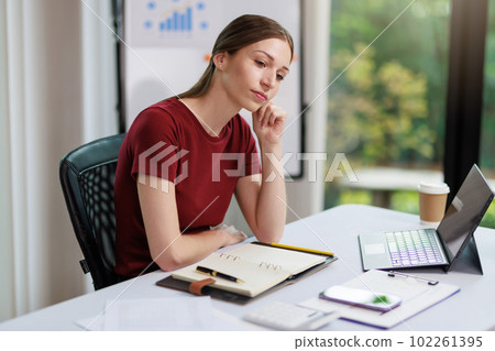 Concept of business office woman working,Businesswoman smile while working about her invesment plan with analyzing document and business investment graph data by using laptop on desk in workstation. Concept of business office woman working,Businesswoman smile while working about her invesment plan with analyzing document and business investment graph data by using laptop on desk in workstation. 102261395