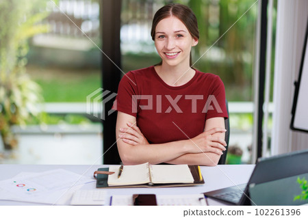 Concept of business office woman working,Businesswoman smile while working about her invesment plan with analyzing document and business investment graph data by using laptop on desk in workstation. Concept of business office woman working,Businesswoman smile while working about her invesment plan with analyzing document and business investment graph data by using laptop on desk in workstation. 102261396