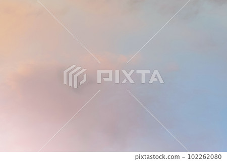Twilight sky with effect of light in pastel pink, coral, orange, blue tones. Colorful sunset of soft clouds. Background 102262080