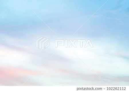 Twilight sky with effect of light in pastel pink, coral, orange, blue tones. Colorful sunset of soft clouds. Background 102262112