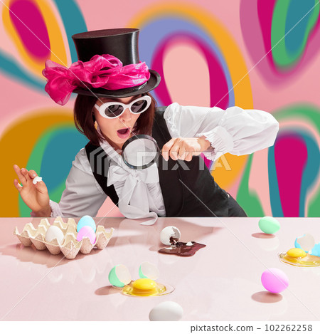 Chocolate detective. Emotional woman in cylinder and sunglasses looking in magnifying glass on egg with chocolate spilling out. Multicolored abstract background Chocolate detective. Emotional woman in cylinder and sunglasses looking in magnifying glass on egg with chocolate spilling out. Multicolored abstract background 102262258