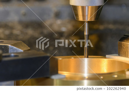The tapping process on NC milling machine at the brass material parts. 102262940