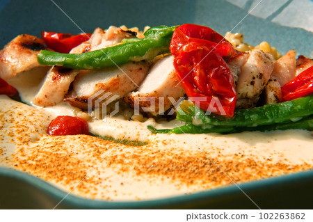 Rabbit Fillet on Dinner Plate Served Green String Beans, Tomatoes and Bulgur Garnished. Art Food Gourmet Meal. Roasted White Meat with Sauce. Trendy Authentic Porcelain. Restaurant Tasty Dish Closeup Rabbit Fillet on Dinner Plate Served Green String Beans, Tomatoes and Bulgur Garnished. Art Food Gourmet Meal. Roasted White Meat with Sauce. Trendy Authentic Porcelain. Restaurant Tasty Dish Closeup 102263862