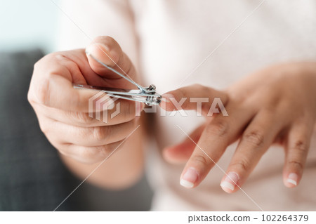Woman cutting fingernails using nail clipper, Healthcare, Beauty Concept. Woman cutting fingernails using nail clipper, Healthcare, Beauty Concept. 102264379