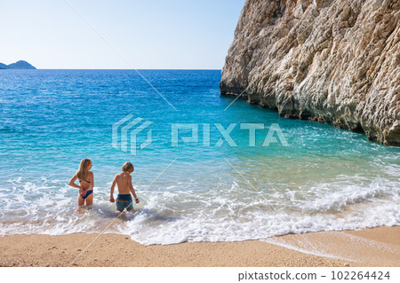 Happy kids looking at turquoise sea water at Kaputas beach 102264424