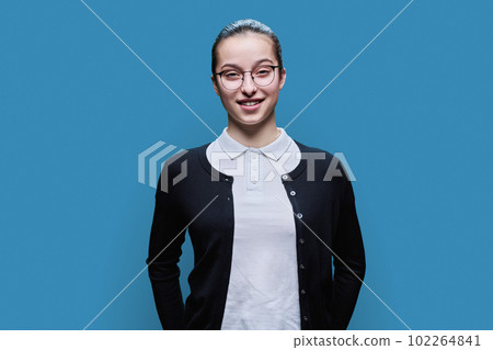 Portrait of happy high school student girl on blue background 102264841