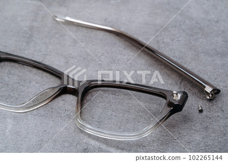 Closeup of glasses with broken temple lying Closeup of glasses with broken temple lying 102265144