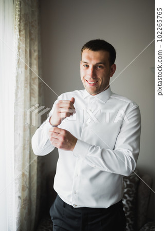Beautiful man, groom posing and preparing for wedding Beautiful man, groom posing and preparing for wedding 102265765